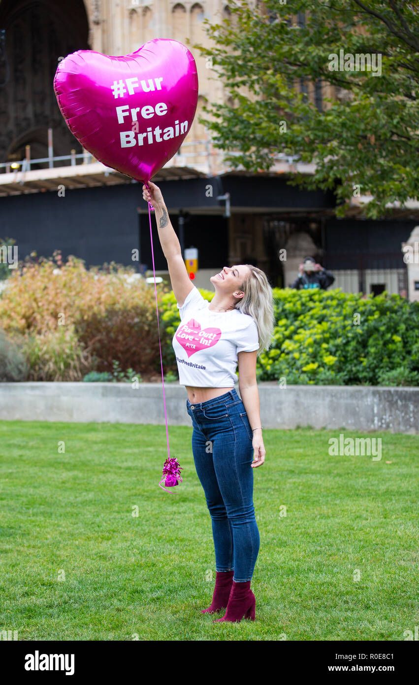 Wearing tops emblazoned with "Fur-Out, Love-In", Love Island's Samira  Mighty, Laura Anderson, and Laura Crane pose outside Parliament on holding  giant, heart-shaped, pink balloons that read, "#FurFreeBritain" Featuring:  Laura Crane Where: London,