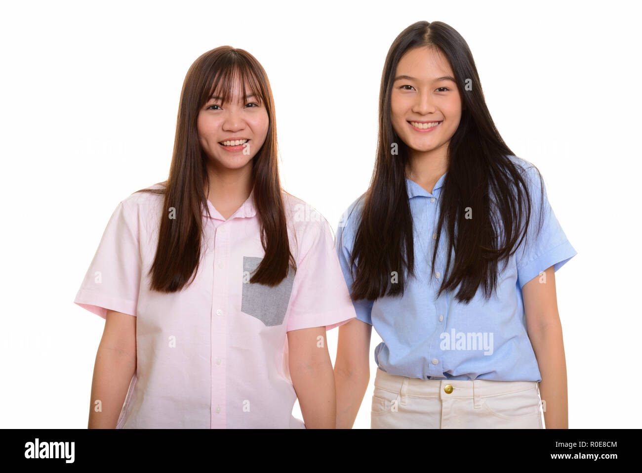 Two young happy Asian teenage girls smiling Stock Photo