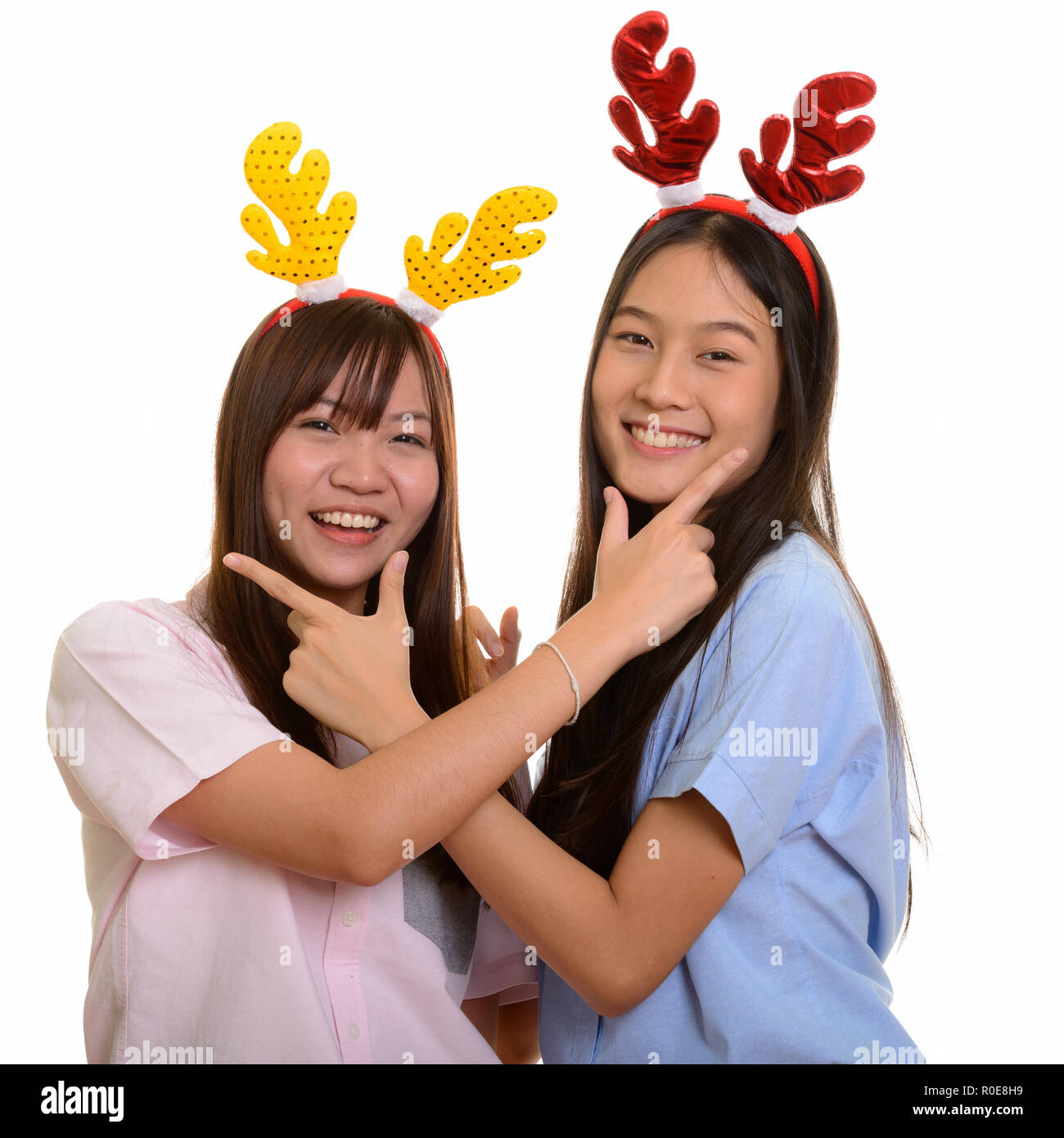 Two young happy Asian teenage girls smiling and posing together Stock ...