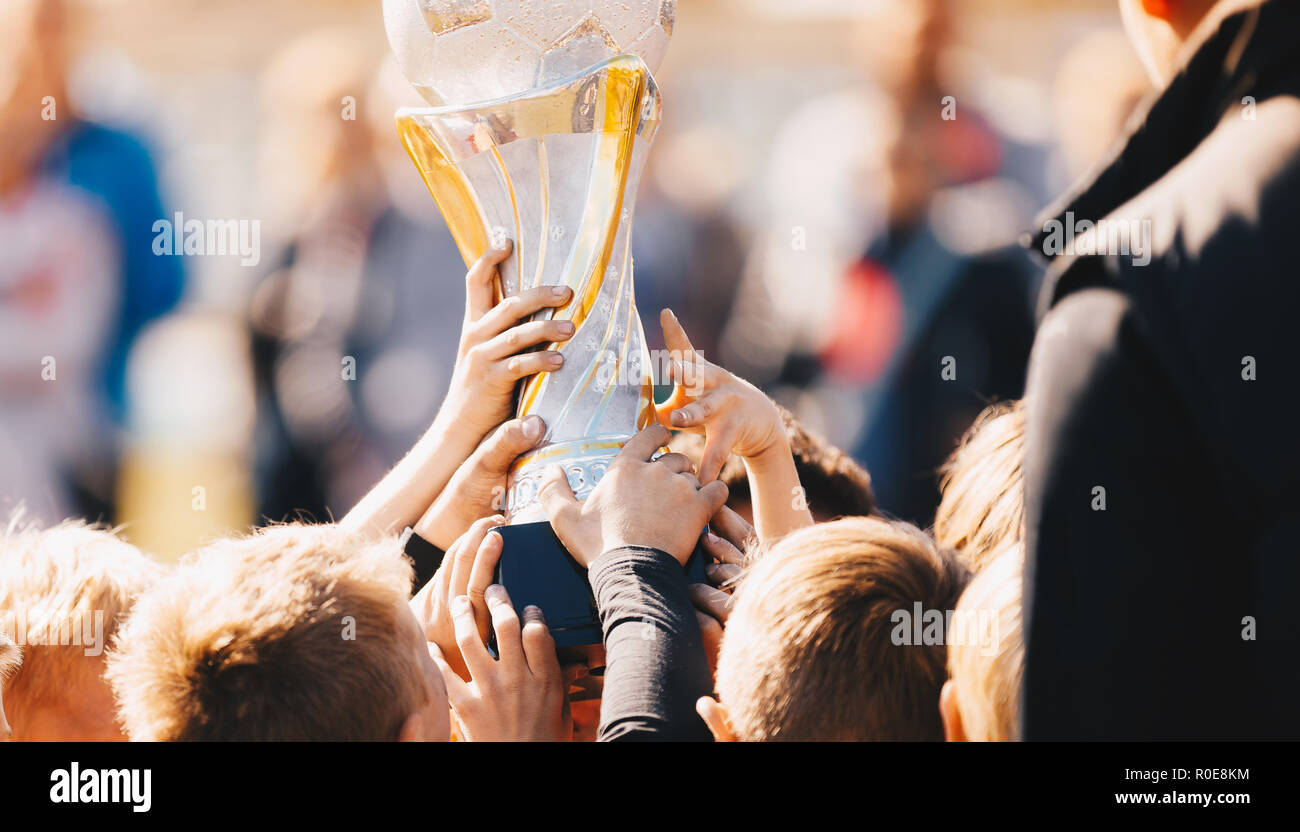 Close-up of Kids Sports Team with Trophy. Boys Celebrating Sports Achievement. Team Sports Champions. Soccer Football Winning Victory Celebration Mome Stock Photo