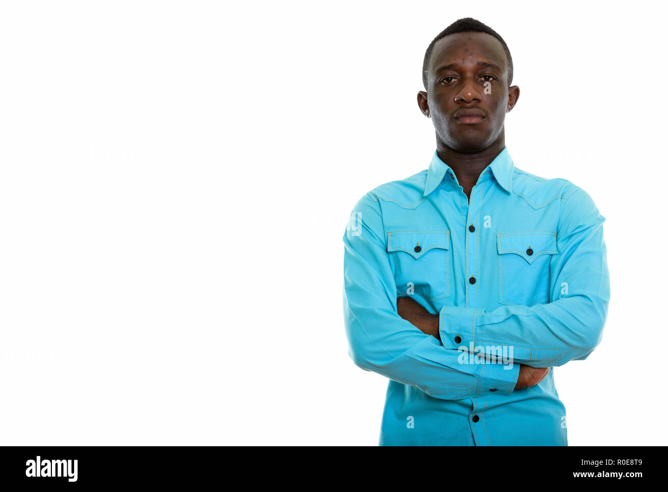 Studio shot of young black African man with arms crossed Stock Photo ...