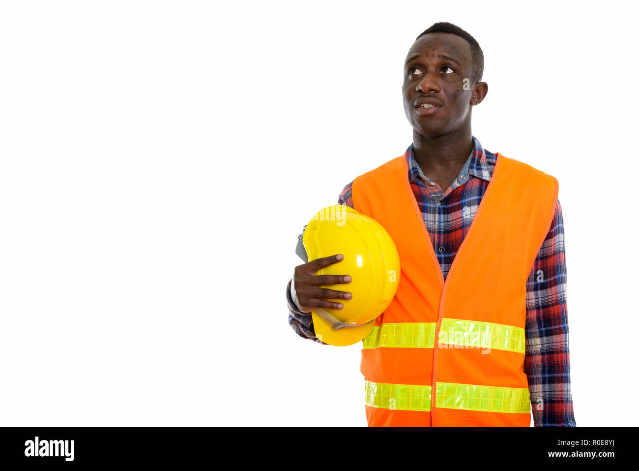 Studio shot of young black African man construction worker think Stock Photo