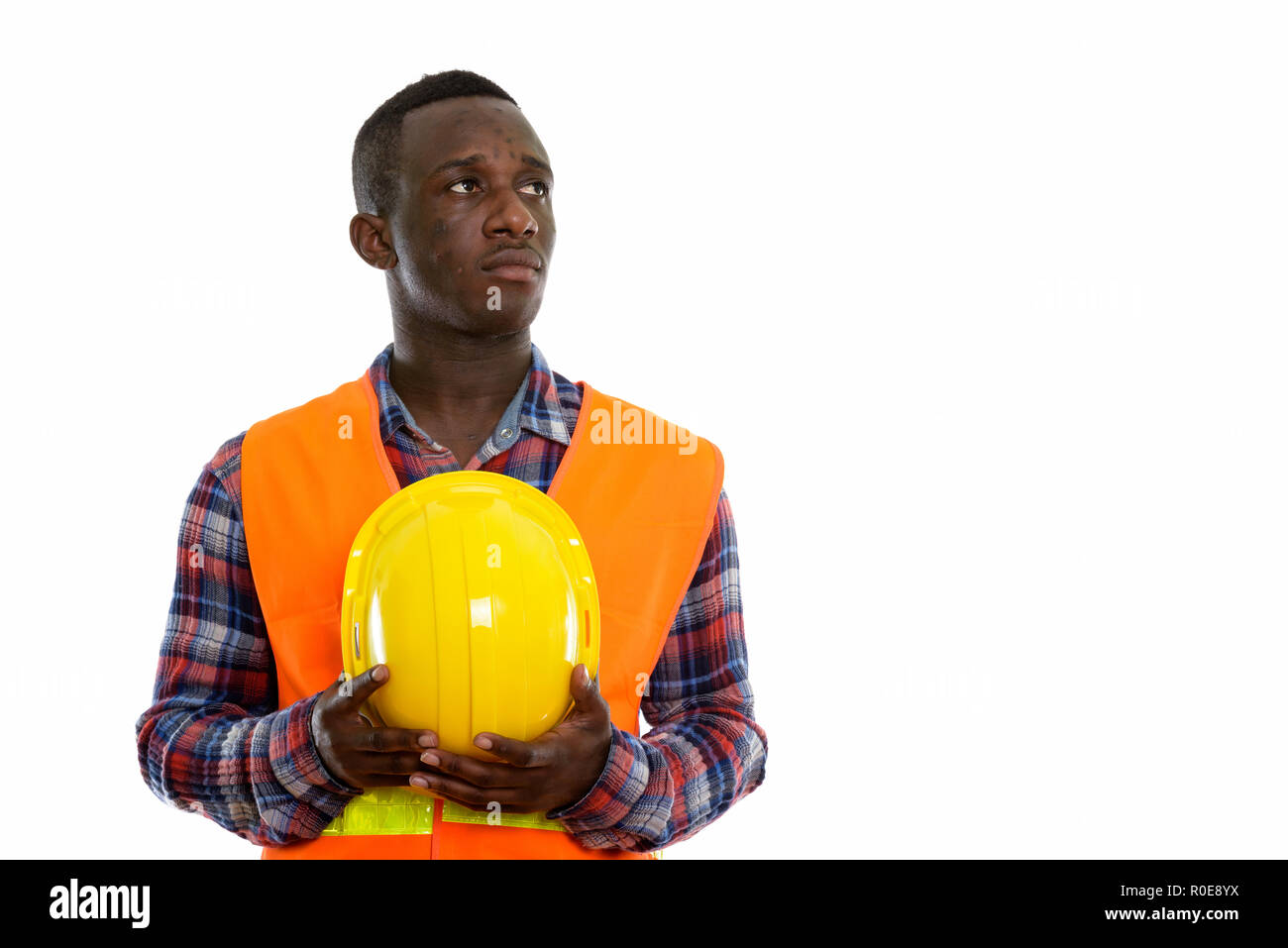 Studio shot of young black African man construction worker think Stock Photo