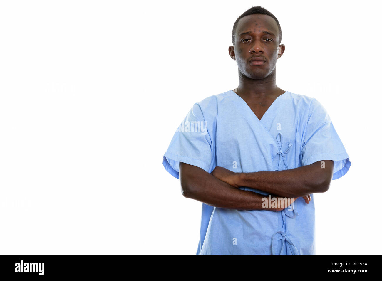 Studio shot of young black African man patient with arms crossed Stock Photo