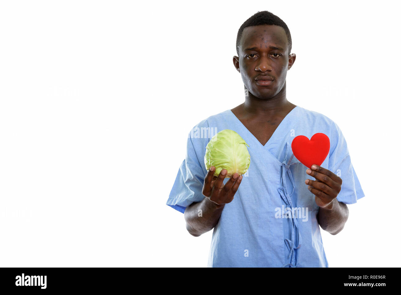 Studio shot of young black African man patient holding green cab Stock ...