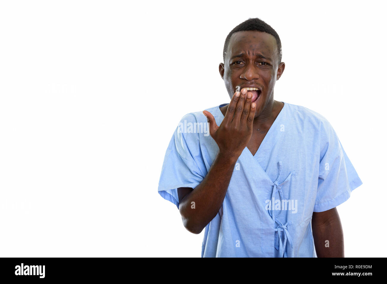Studio shot of young happy black African man patient smiling and Stock Photo