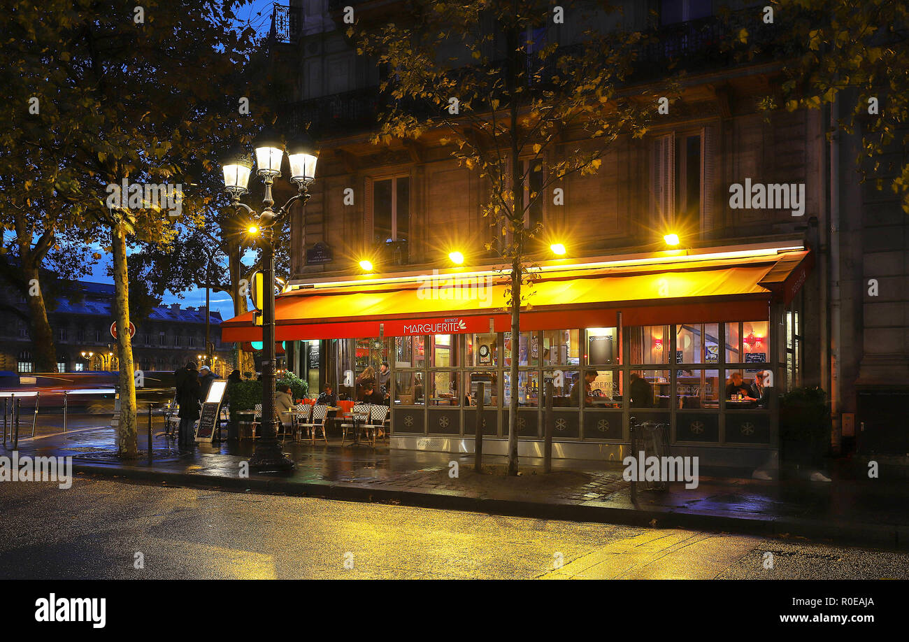 Typical Parisian cafe Marguerite at rainy night located next town hall ...