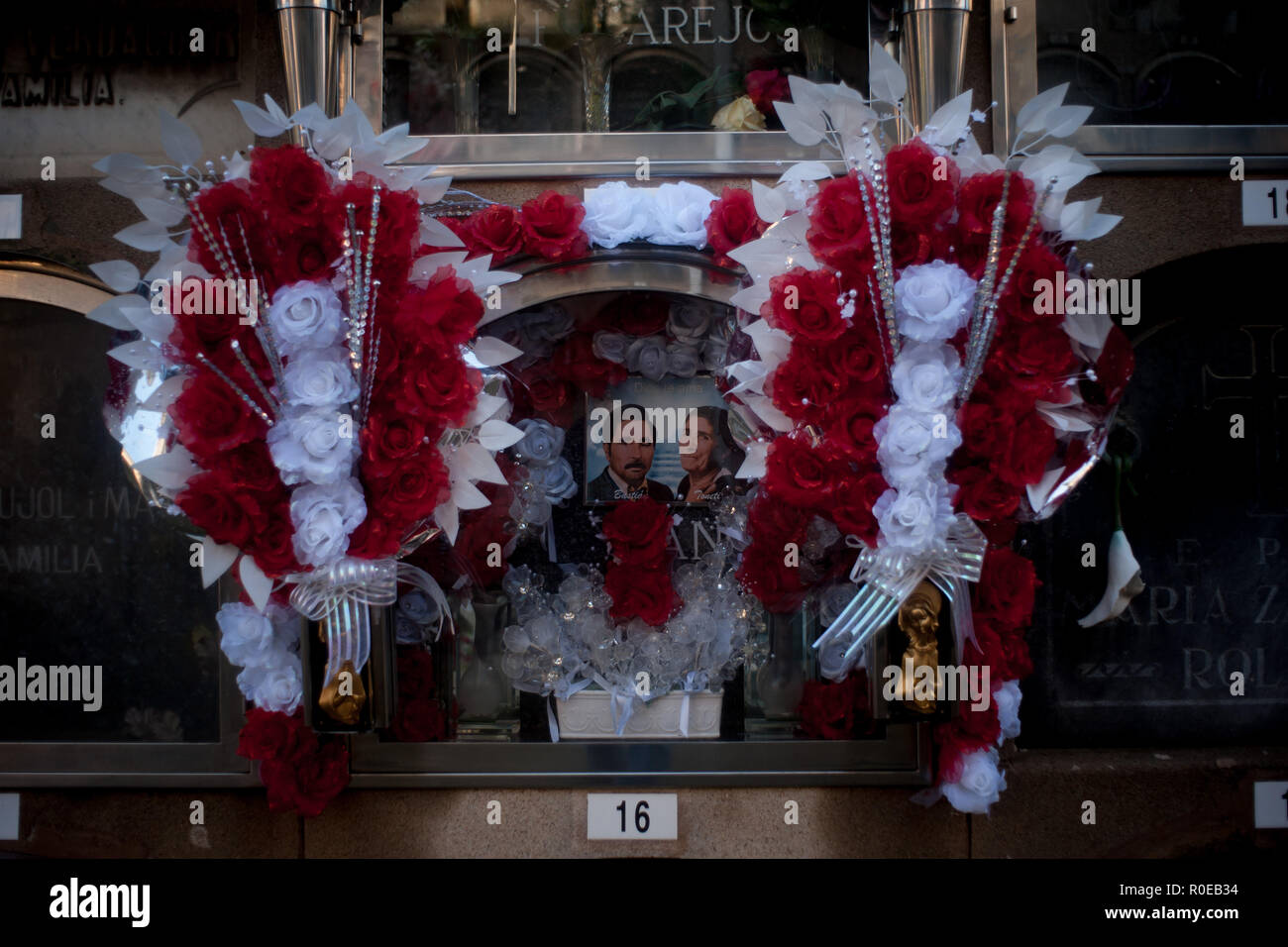 Fllowers decorate a grave  at Poblenou cemetery in Barcelona, Catalonia, Spain, on November 1, 2018. All Saints Day, the traditional catholic feast de Stock Photo