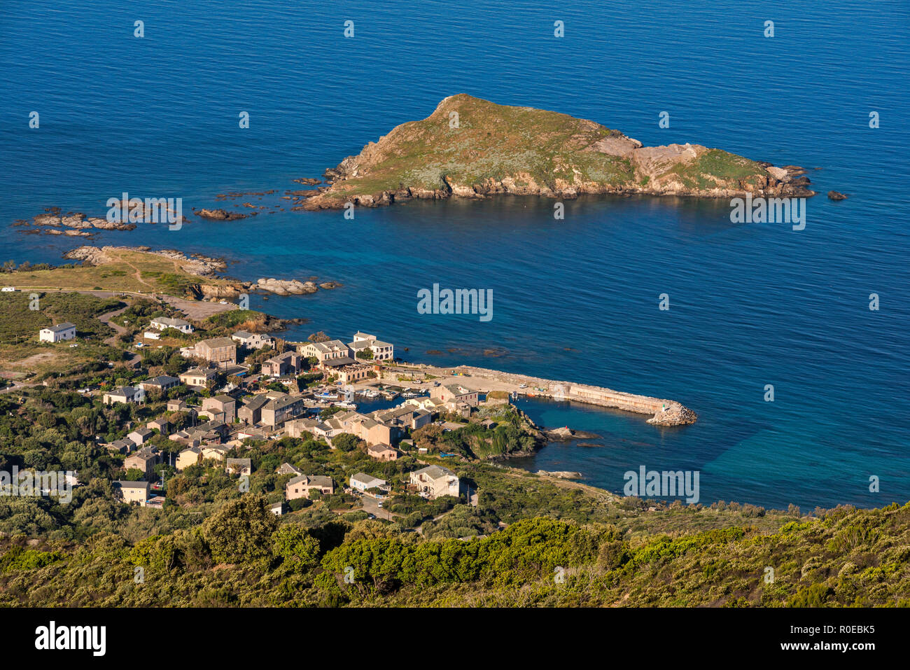 Town and port of Centuri, Ilot de Capense in distance, Cap Corse, Haute-Corse, Corsica, France Stock Photo