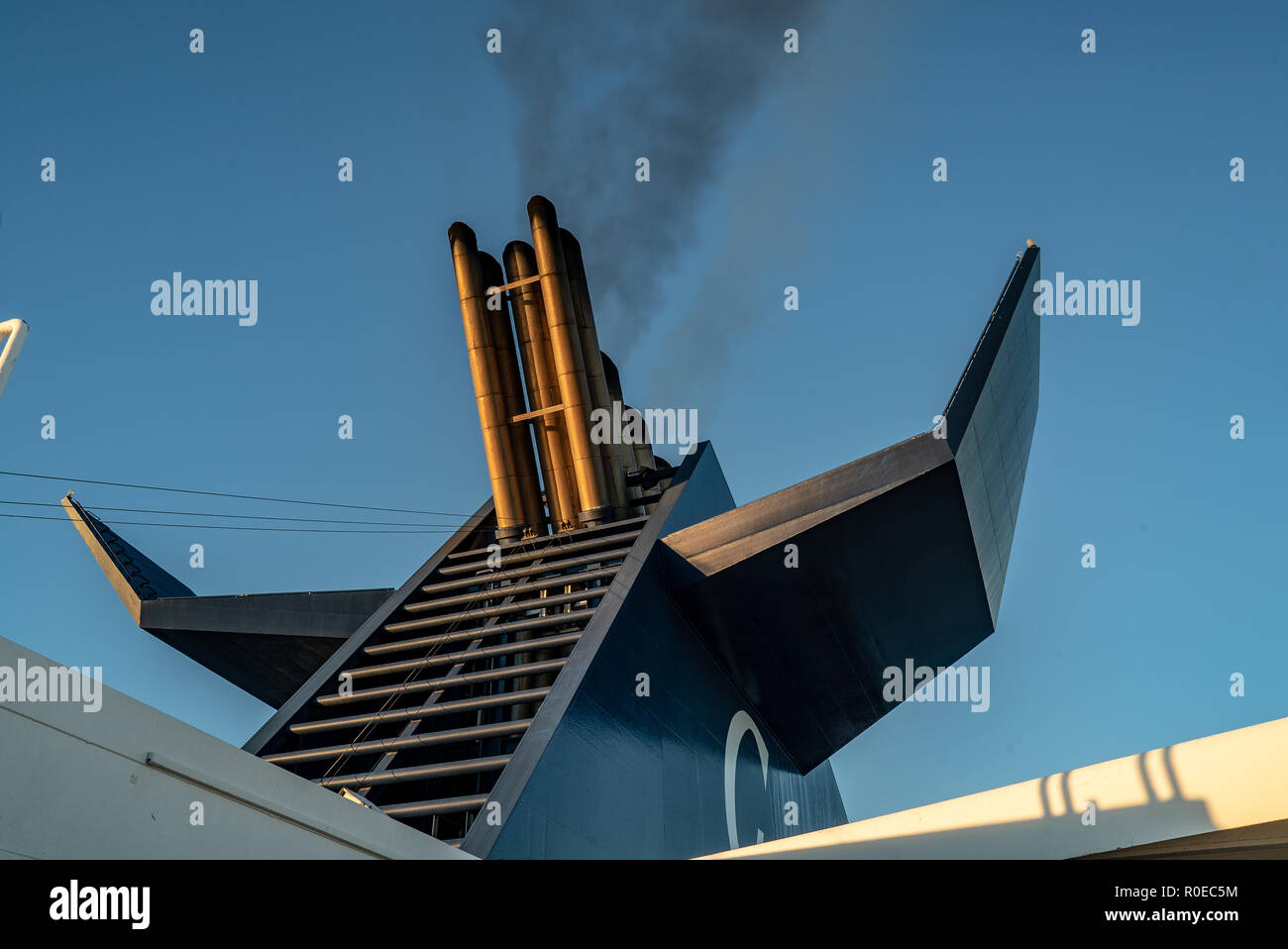 Chimney of a ferry boat with smoke and blue sky Stock Photo