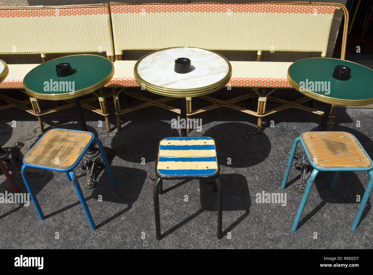 Colorful seats and traditional French bistro tables outside a cafe on Rue Mouffetard, Paris, France. Stock Photo