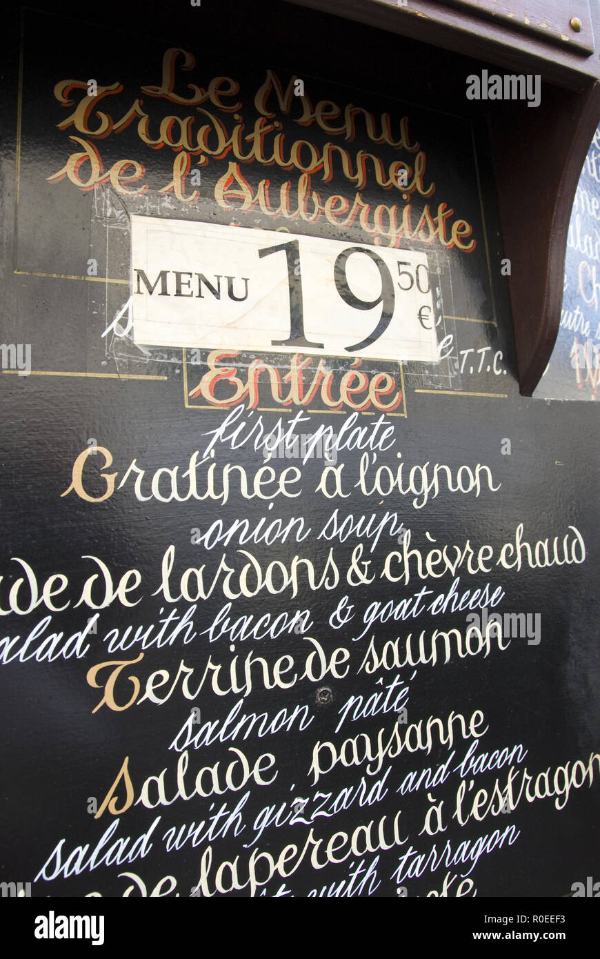 A restaurant offers a fixed-price meal (prix-fixe menu) on a sign on Rue Mouffetard, a popular street lined with cafes, bars, souvenir shops and an op Stock Photo