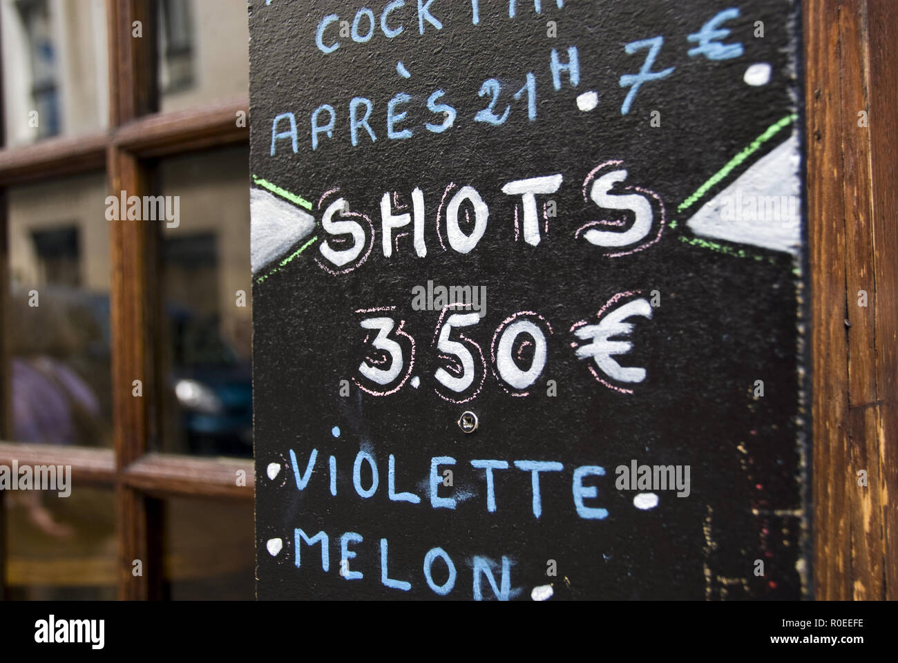 A sign offers 'shots' at a bar on Rue Mouffetard, Paris, France. Stock Photo