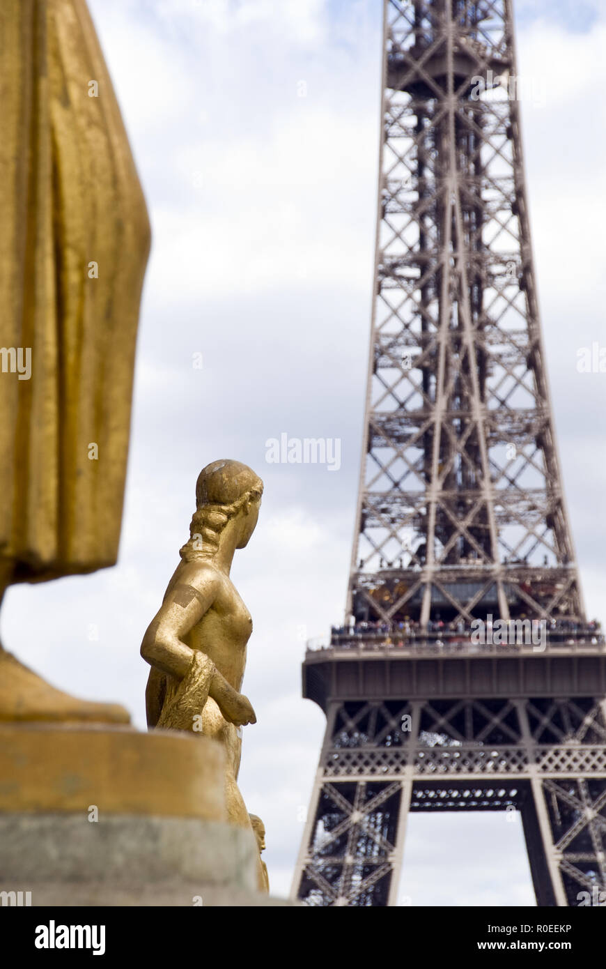 The Eiffel Tower as seen from the Place du Trocadero where gold figures stand representing the rights of man, Paris, France. Stock Photo