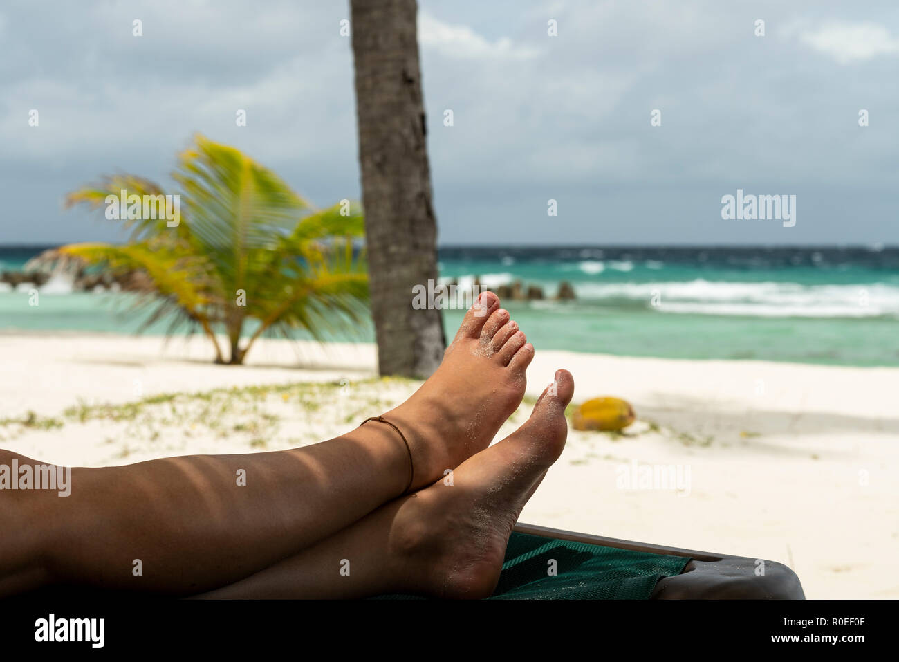 A woman is relaxing on a beach at the Maldives. Stock Photo