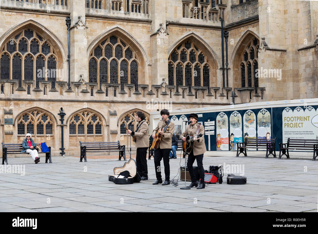 A Beatles tribute band busking in Bath Abbey courtyard, Bath, England, UK Stock Photo