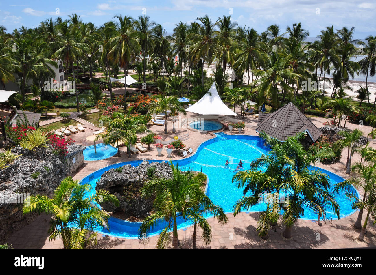 Tourists & guests in the pool-area at the Diani Reef Beach & Spa Resort at the southern coast of Mombasa Stock Photo