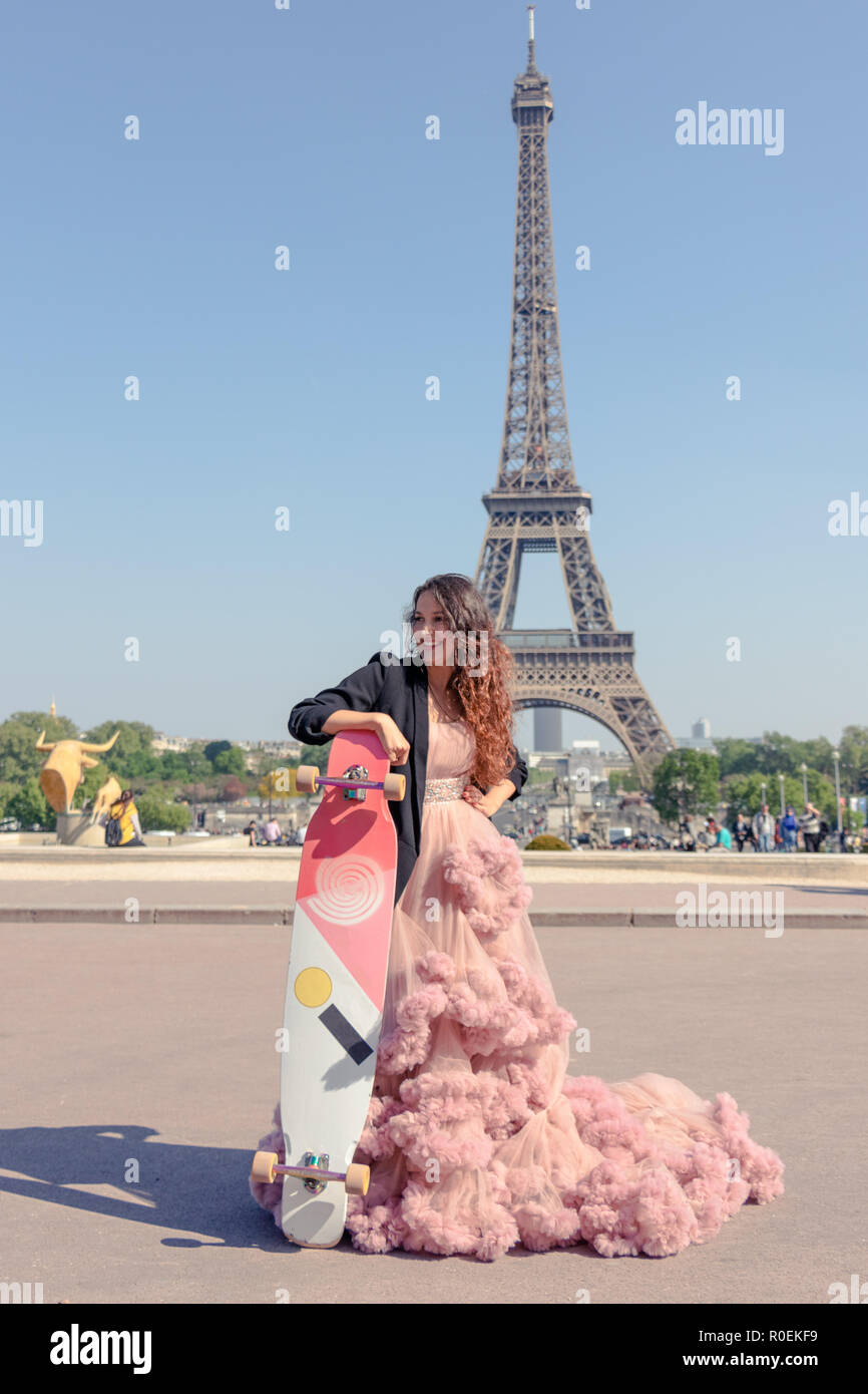 Beautiful hipster girl dressed to impress in a pink ballroom dress holding a long board with Eiffel Tower in the background Stock Photo - Alamy Beautiful hipster girl dressed to impress in a pink ballroom dress holding a long board with Eiffel Tower in the background Stock Photo - Alamy