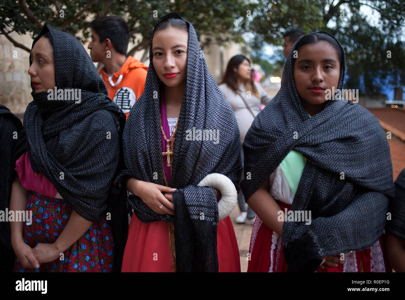 Young women dressed with traditional clothing during a religious celebration outside the Templo de Santo Domingo church in Oaxaca, Mexico Stock Photo