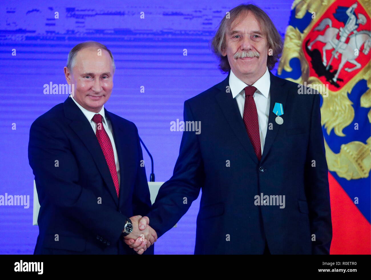 Czech songwriter and poet Jaromir Nohavica (R) receives a Medal of Pushkin  from the President of Russia Vladimir Putin at a ceremony to award foreign  nationals for their contribution to strengthening international