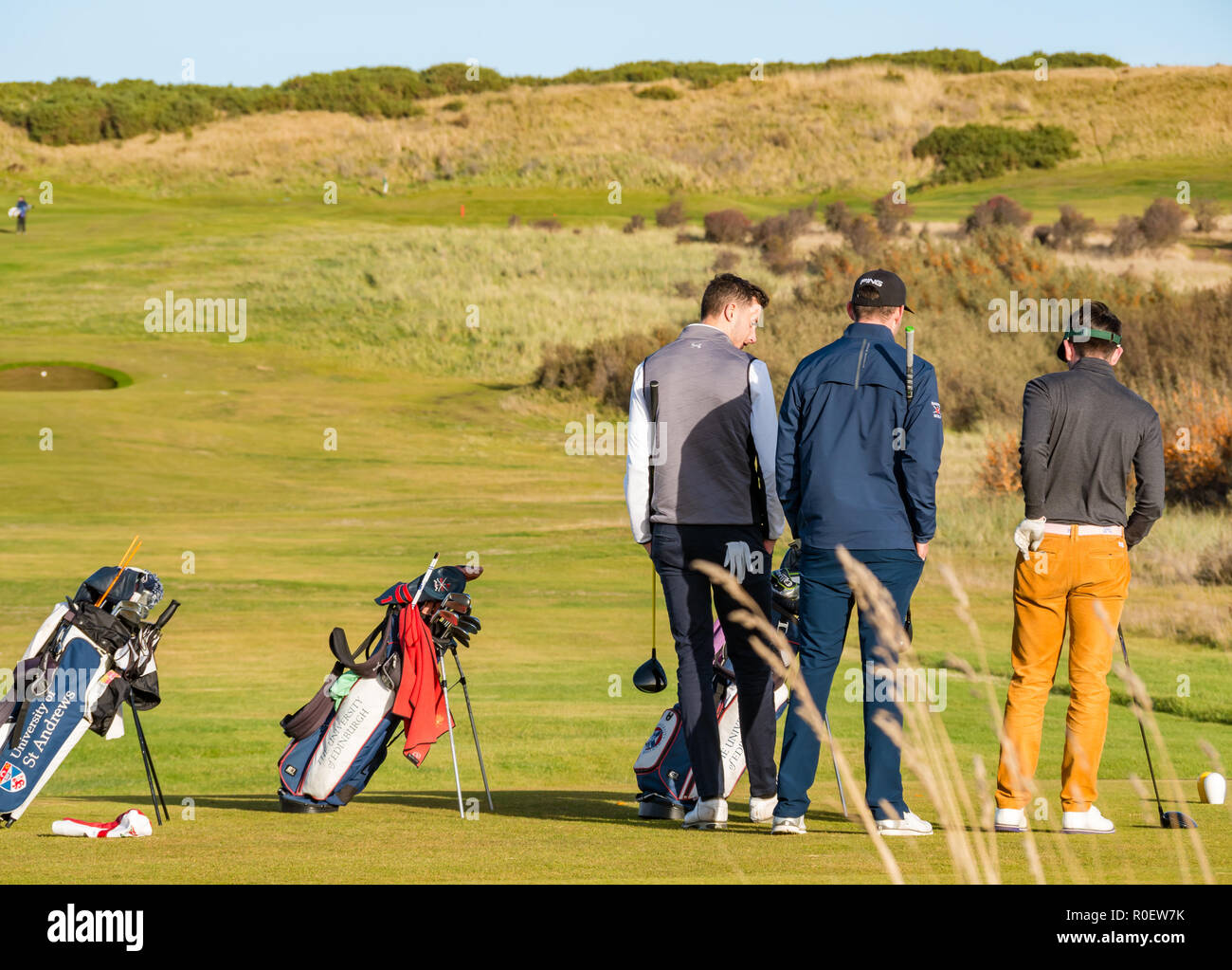 Aberlady nature reserve, East Lothian, Scotland, United Kingdom, 4th November 2018. UK Weather: warm sunny Autumn day on golf links. Young male golfers on Gullane golf course Stock Photo