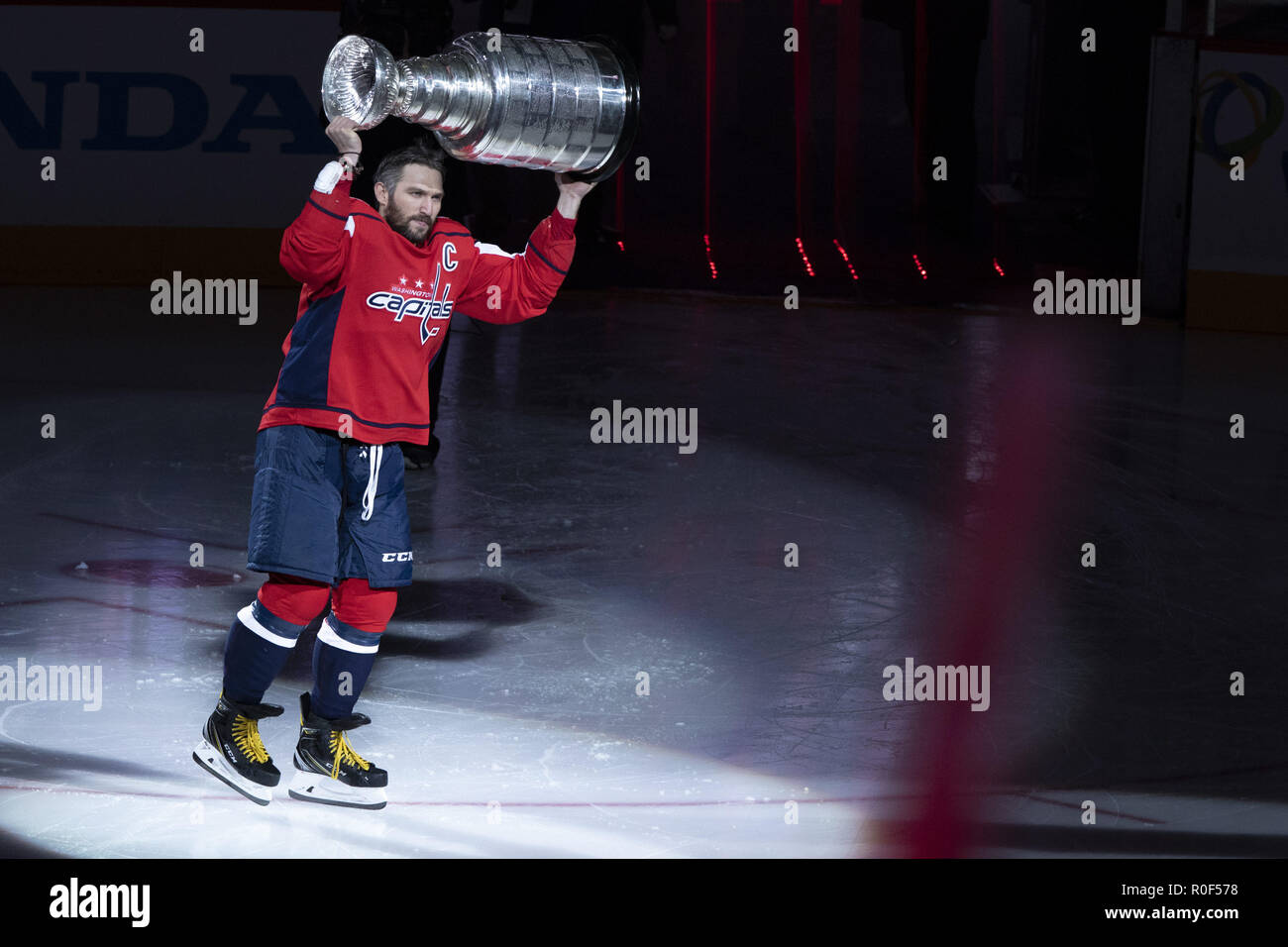 Washington, DC, USA. 3rd Oct, 2018. Washington Capitals left wing Alex Ovechkin (8) raises the Stanley Cup as he takes the ice during the Stanley Cup banner raising ceremony prior to the game between the Boston Bruins and Washington Capitals at Capitol One Arena in Washington, DC on October 3, 2018. The Washington Capitals won the 2018 Stanley Cup. Credit: Alex Edelman/ZUMA Wire/Alamy Live News Stock Photo