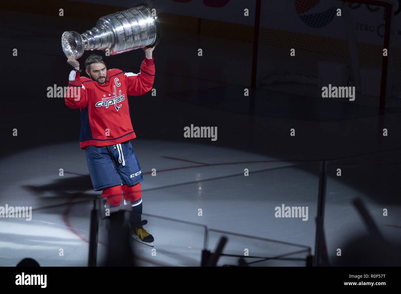 Washington, DC, USA. 3rd Oct, 2018. Washington Capitals left wing Alex Ovechkin (8) raises the Stanley Cup as he takes the ice during the Stanley Cup banner raising ceremony prior to the game between the Boston Bruins and Washington Capitals at Capitol One Arena in Washington, DC on October 3, 2018. The Washington Capitals won the 2018 Stanley Cup. Credit: Alex Edelman/ZUMA Wire/Alamy Live News Stock Photo