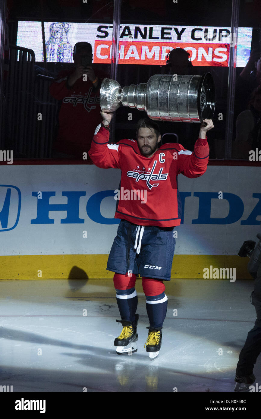 Washington, DC, USA. 3rd Oct, 2018. Washington Capitals left wing Alex Ovechkin (8) raises the Stanley Cup as he takes the ice during the Stanley Cup banner raising ceremony prior to the game between the Boston Bruins and Washington Capitals at Capitol One Arena in Washington, DC on October 3, 2018. The Washington Capitals won the 2018 Stanley Cup. Credit: Alex Edelman/ZUMA Wire/Alamy Live News Stock Photo