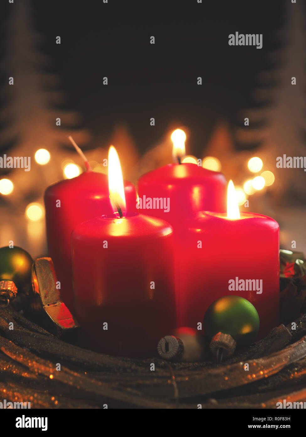Third Advent Candle Burning With Christmas Decoration In A Dark