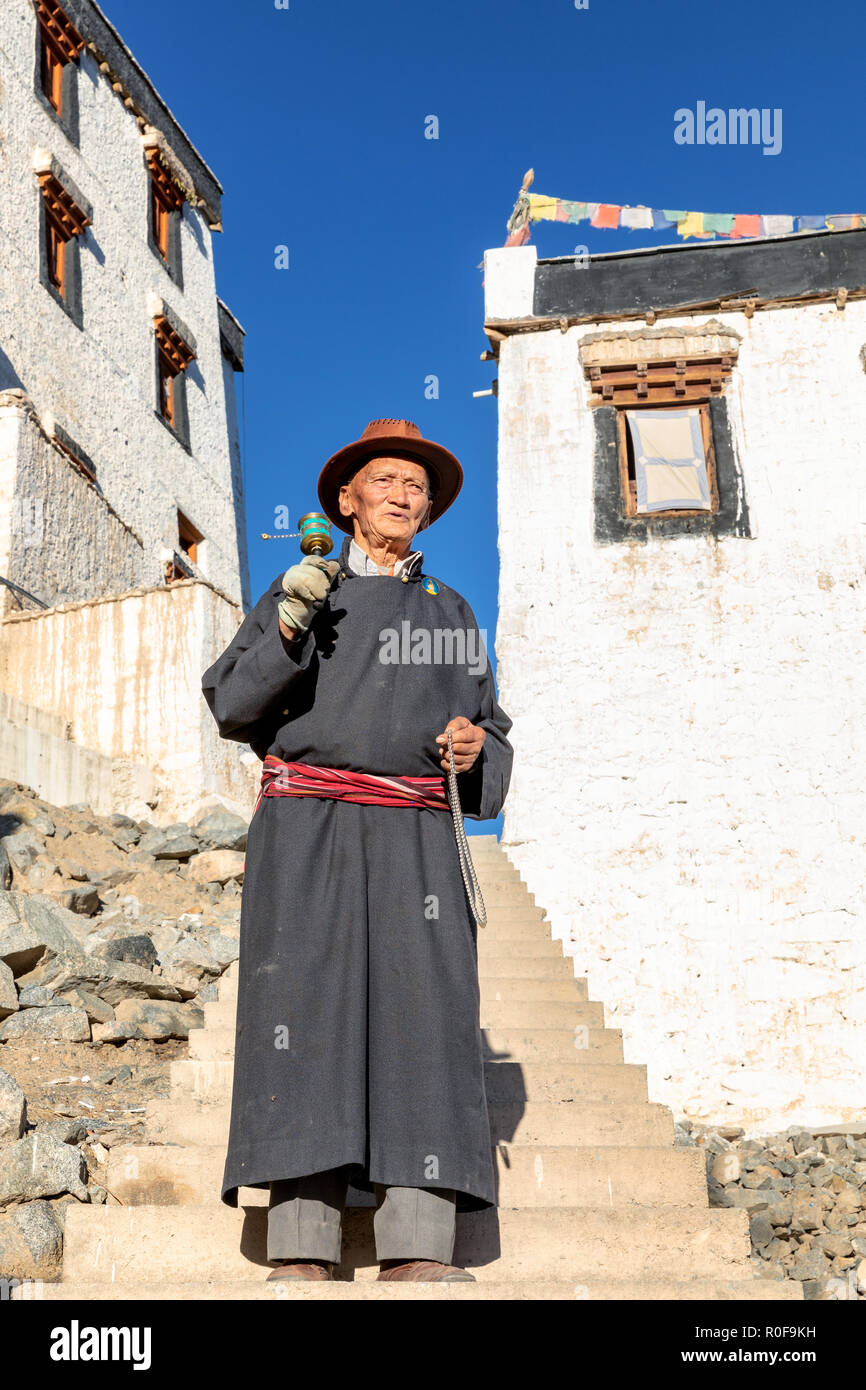 Elderly man with a prayer wheel at Spituk Gompa, Leh district, Ladakh, India Stock Photo