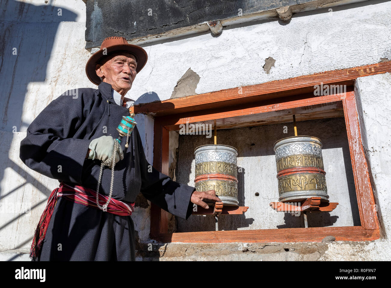 Portrait of elderly man and prayer wheels, Spituk Gompa, Leh district, Ladakh, India Stock Photo