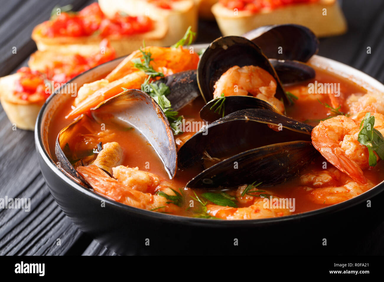 Freshly cooked seafood bouillabaisse soup with shrimps, fish fillets
