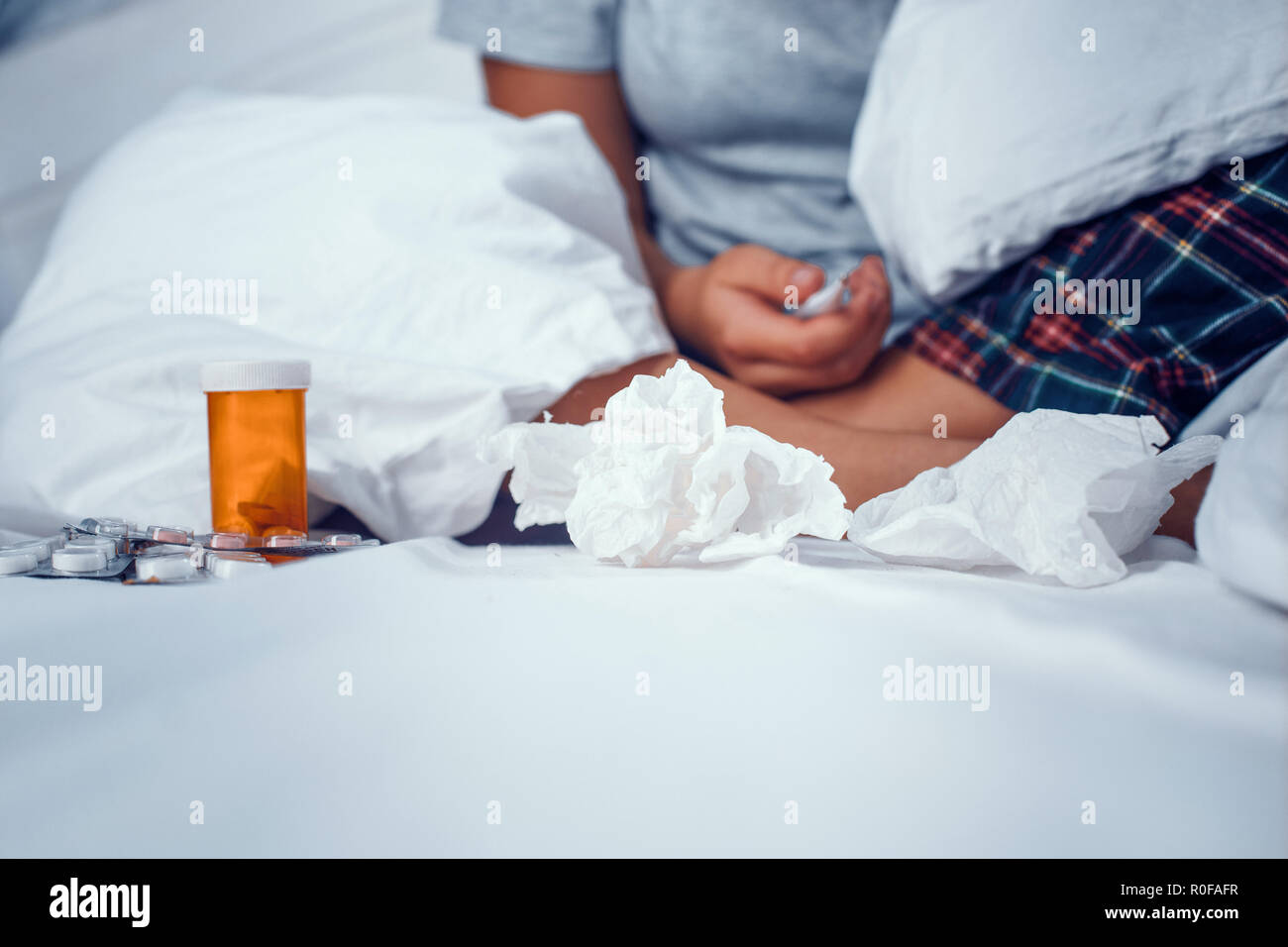 Detailed view on the bottle of pills laying on the bed Stock Photo