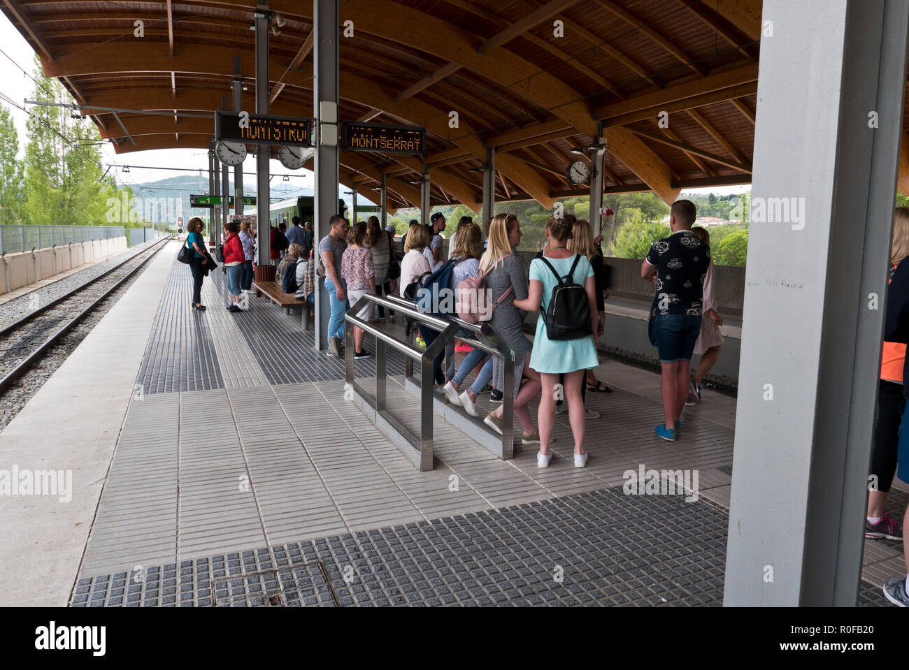 Tourists waiting on the platform for the arrival of the funicular train at Monserrat , Barcelona, Spain Stock Photo
