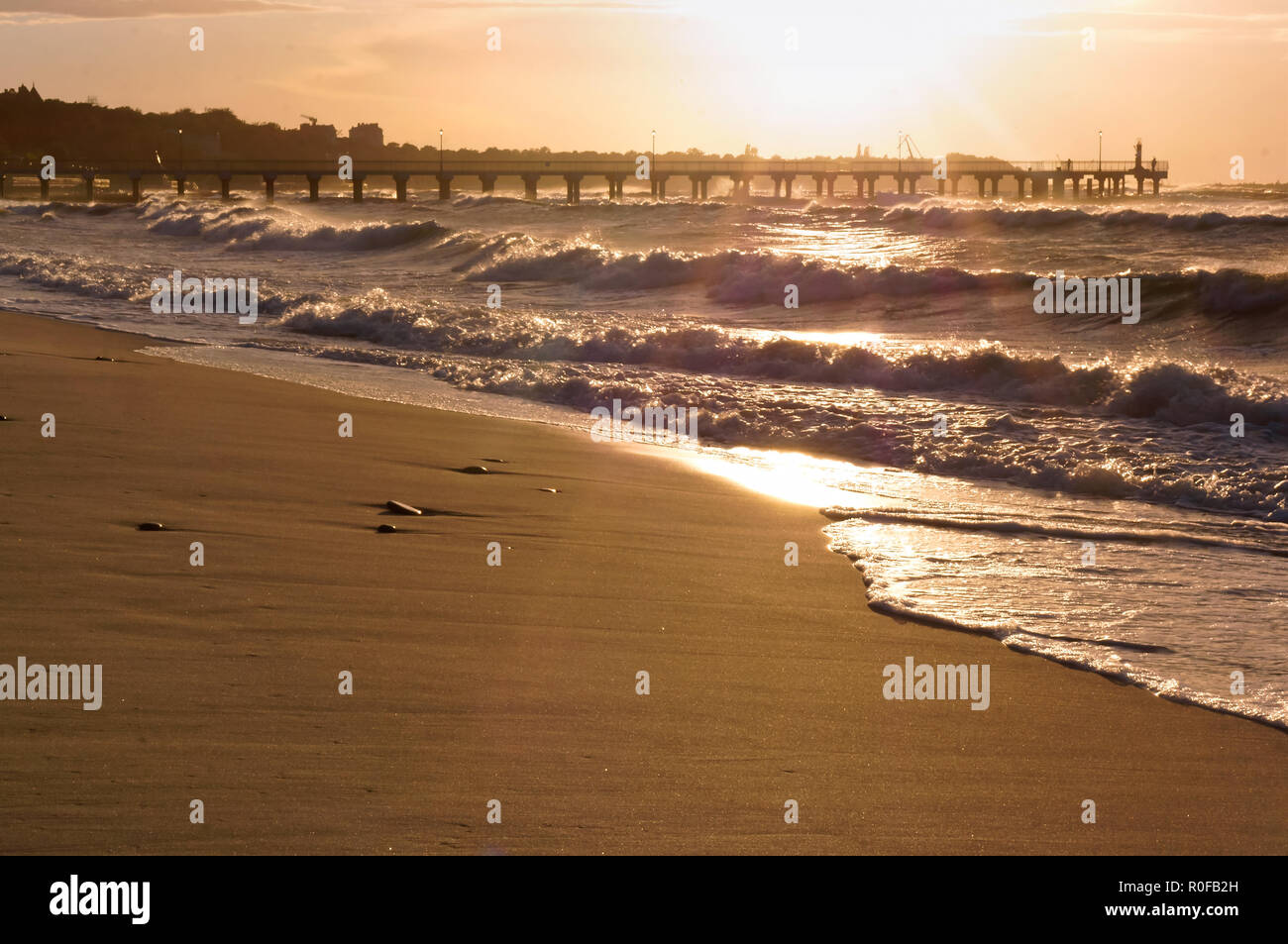 Sunset over the sea. Reflection of sunlight in the sea waves. Red sky in the rays of the sunset. Stock Photo