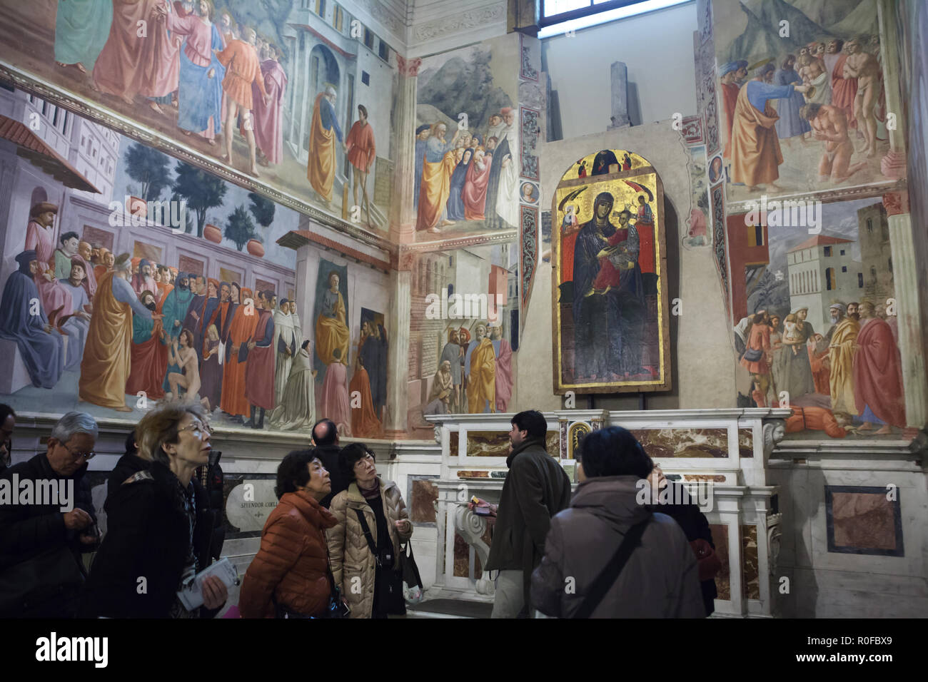 Tourists visit the Brancacci Chapel (Cappella Brancacci) in the Church of Santa  Maria del Carmine in Florence, Tuscany, Italy. Frescos by Italian  Renaissance painters Masaccio and Masolino da Panicale (1420-1427)  completed by