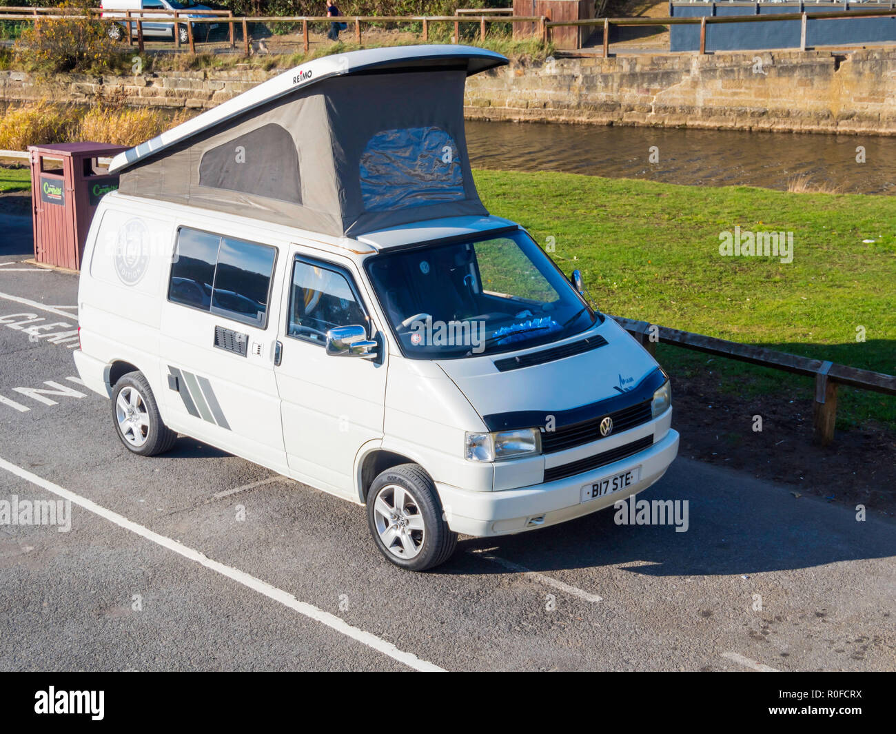 A White Volkswagen Wolfsburg Edition motor caravan with the roof up, parked at the seaside in North Yorkshire Stock Photo