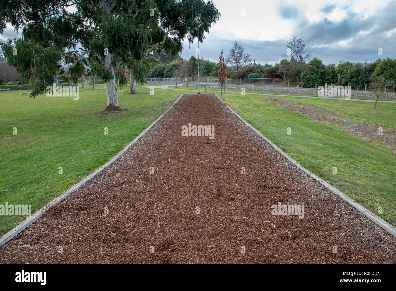 Bark chip mulch under a flying fox in a children's playground Stock Photo