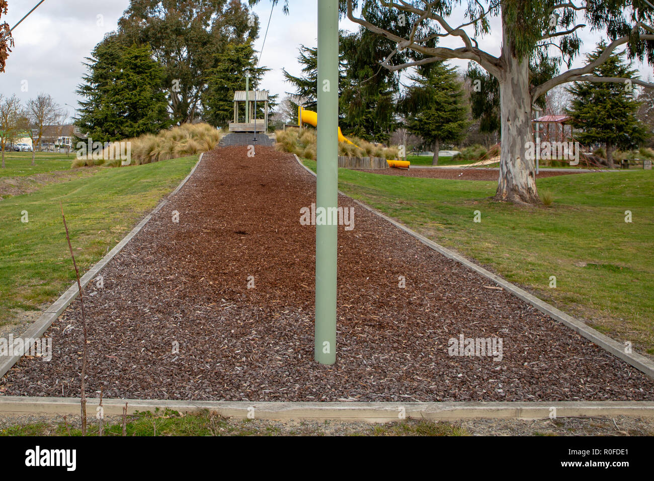 Bark chip mulch under a flying fox in a children's playground Stock Photo