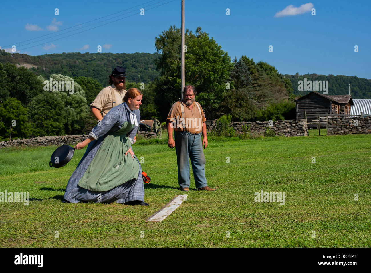 Women throw cast iron pans during a cast iron pan throwing contest at a