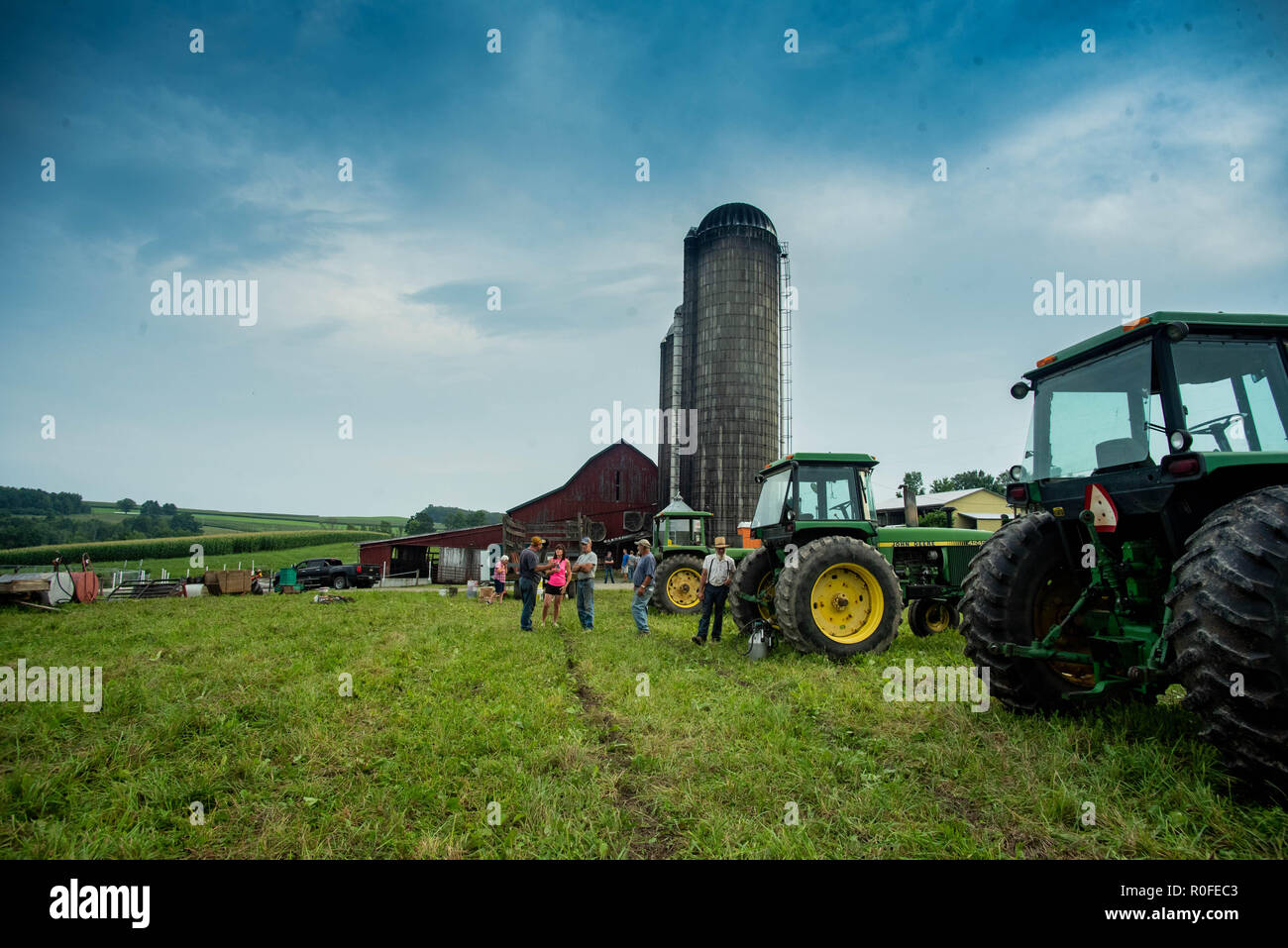 An auctioneer auctions off farm equipment at a family-run farm in the United States. Stock Photo