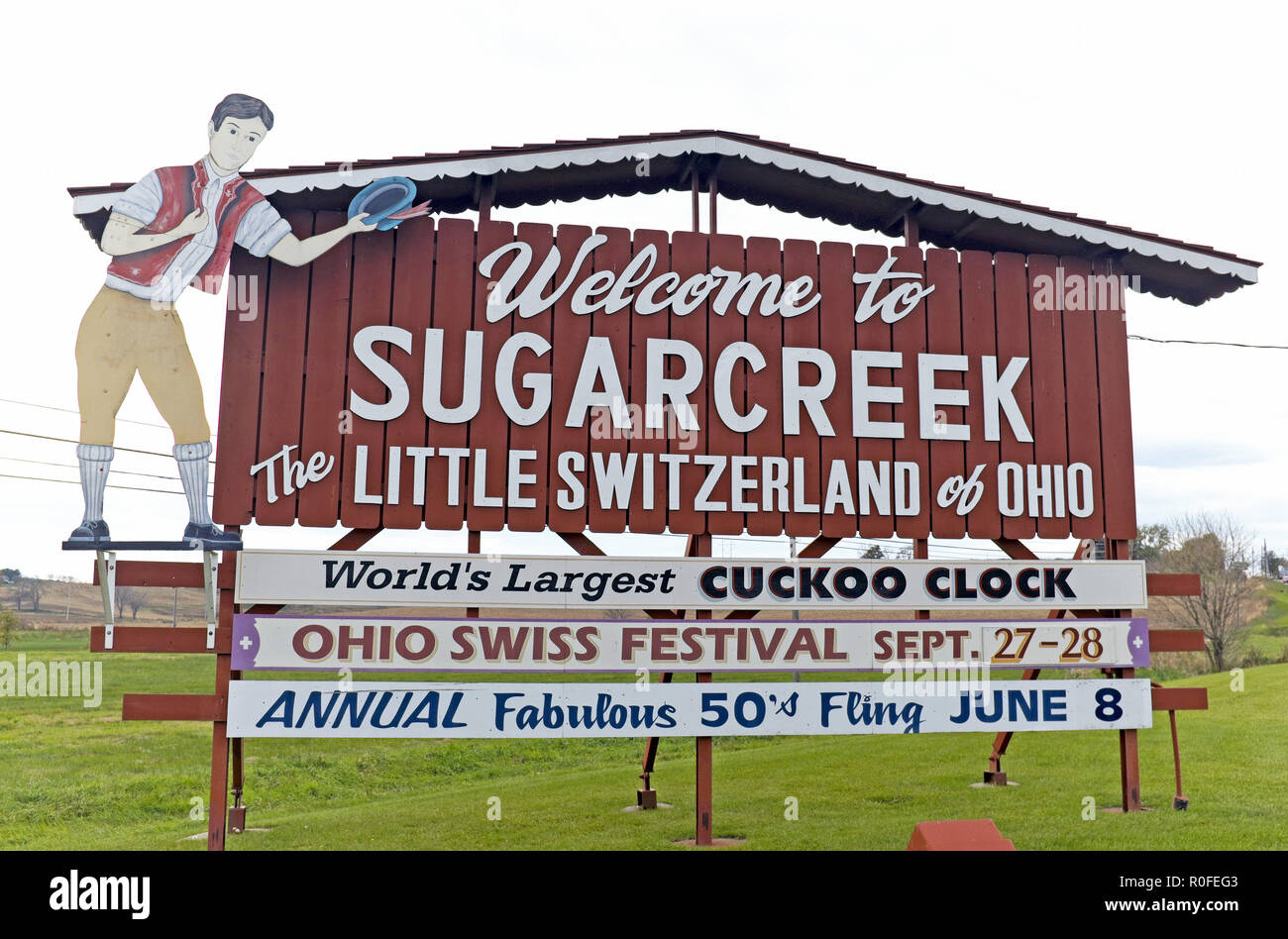 A 'Welcome to Sugarcreek: The Little Switzerland of Ohio' sign welcomes travelers to the Ohio Amish country town of Sugarcreek. Stock Photo