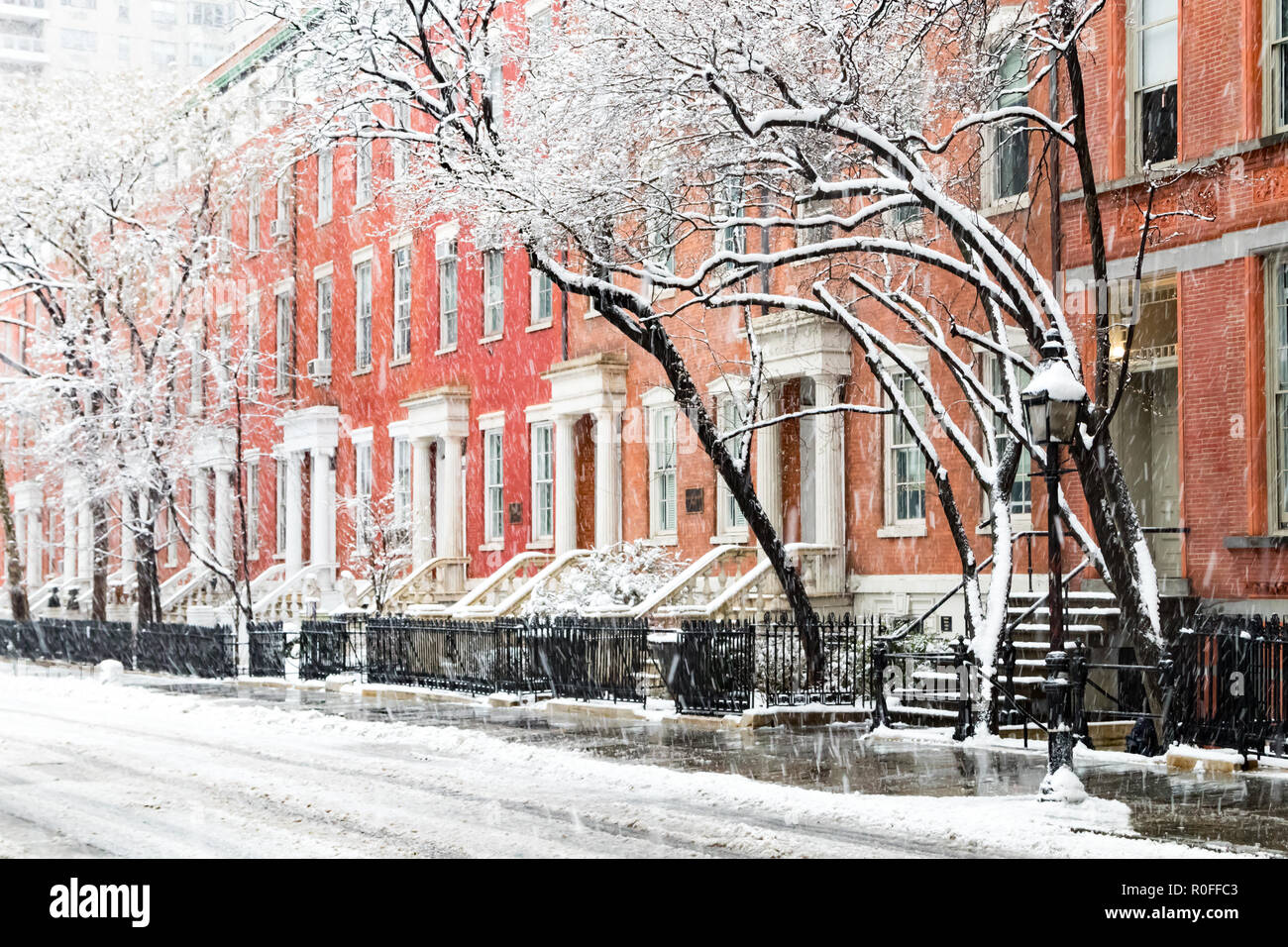 Snow covered winter street scene with view of the historic buildings along Washington Square Park in New York City after nor'easter storm Stock Photo