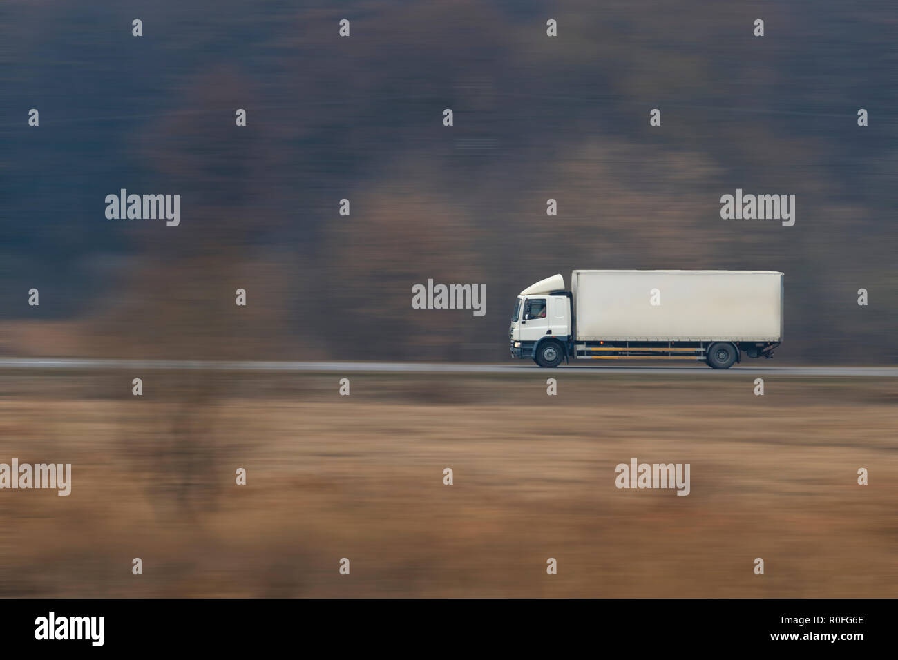 Truck going fast on a suburban road Stock Photo