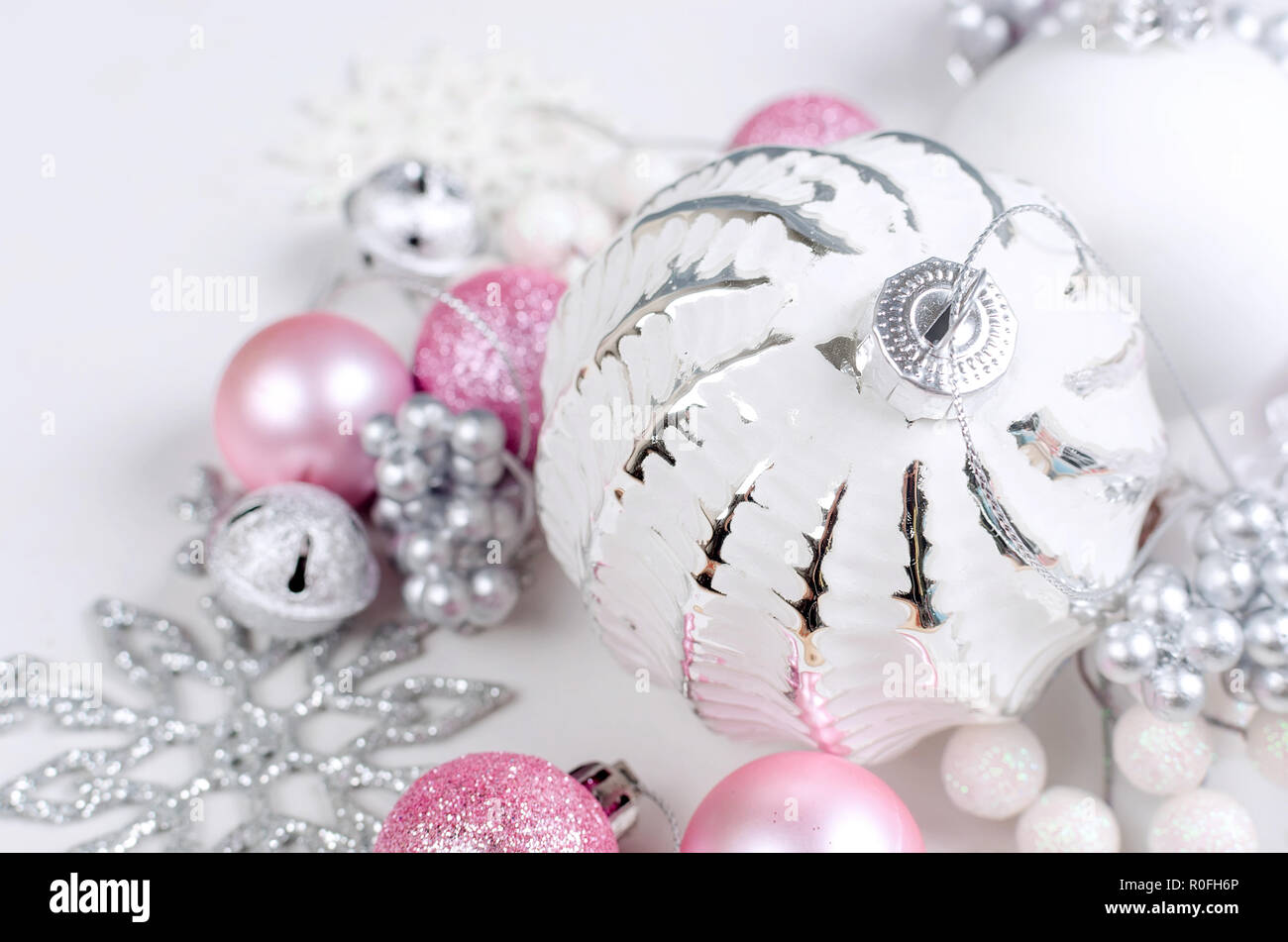 Variety pink and white Christmas holiday decoration, ball and toys on a ...