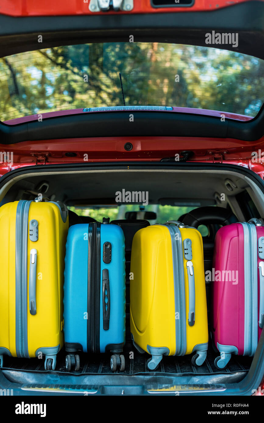 colored wheeled bags in car trunk Stock Photo Alamy