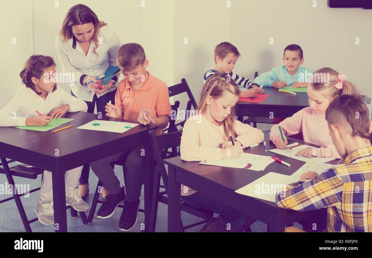 Group of children in elementary age drawing together at classroom Stock ...