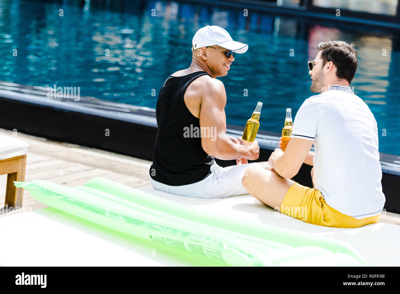 people-sitting-near-pool-hi-res-stock-photography-and-images-alamy