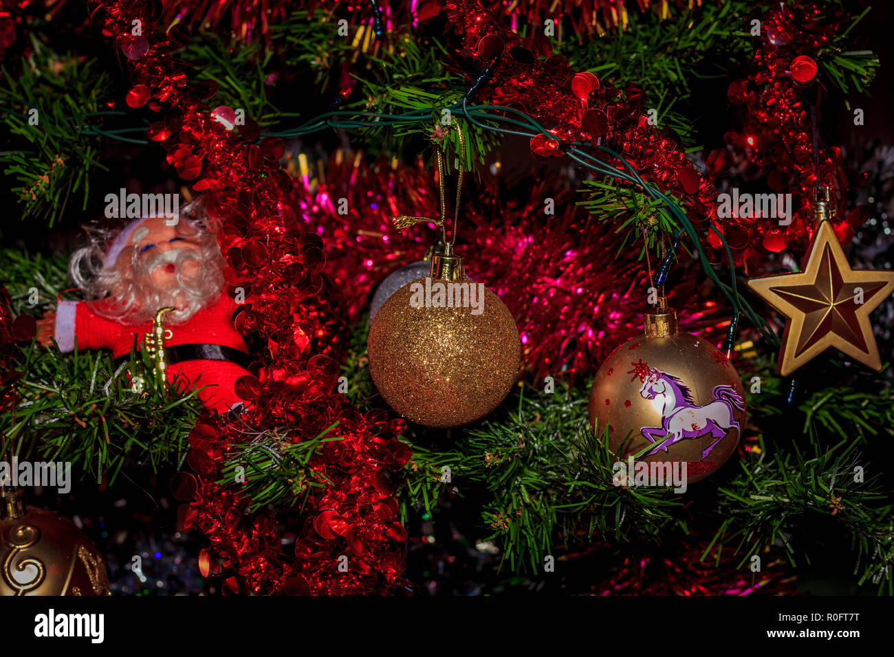 Closeup Of Red Bauble Hanging From A Decorated Christmas Tree