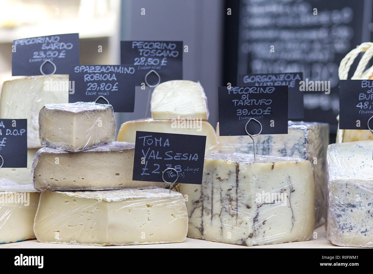 Assorted Cheeses on a market stall Stock Photo